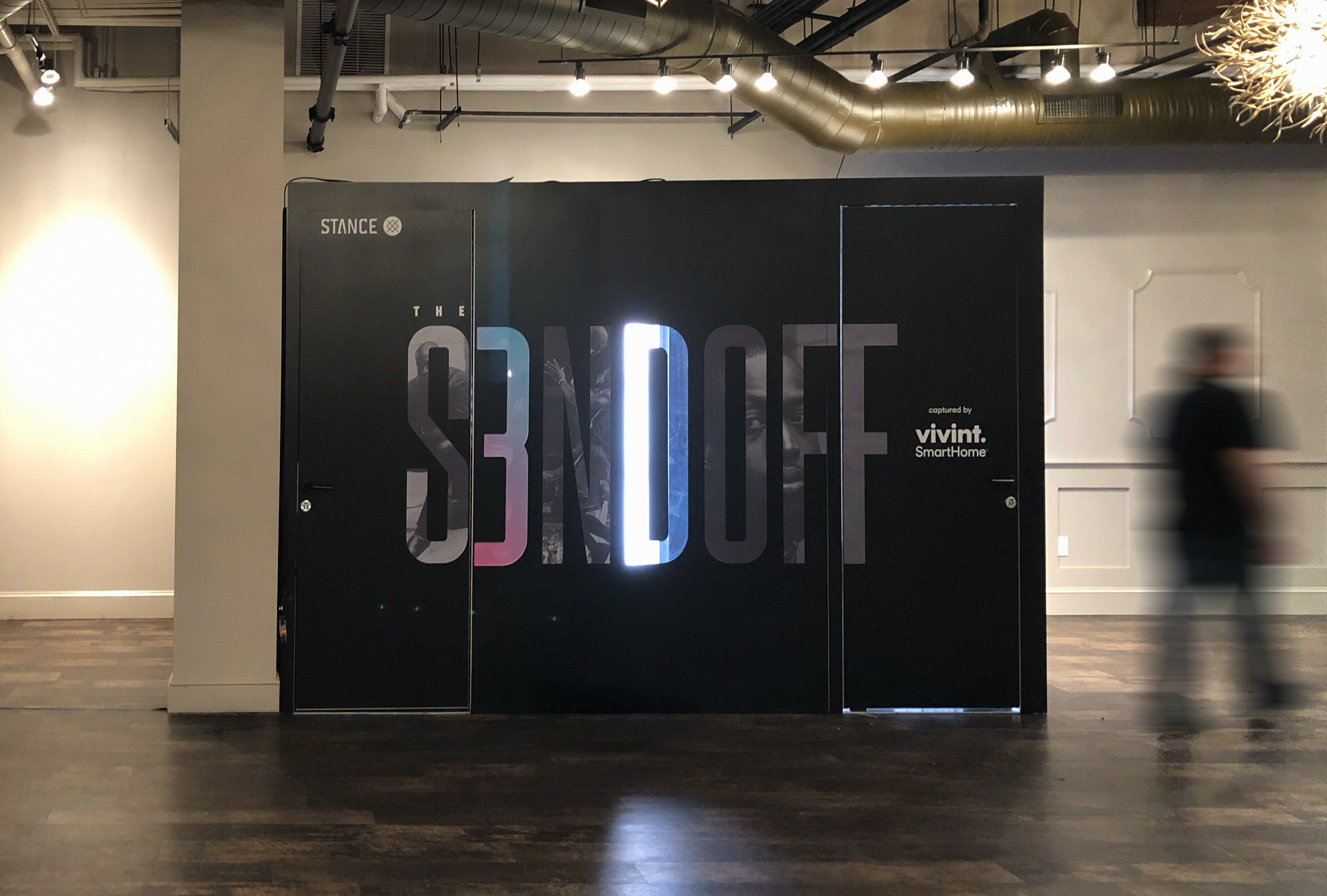 The black S3NDOFF booth on the venue floor, branded Stance and captured by Vivint SmartHome