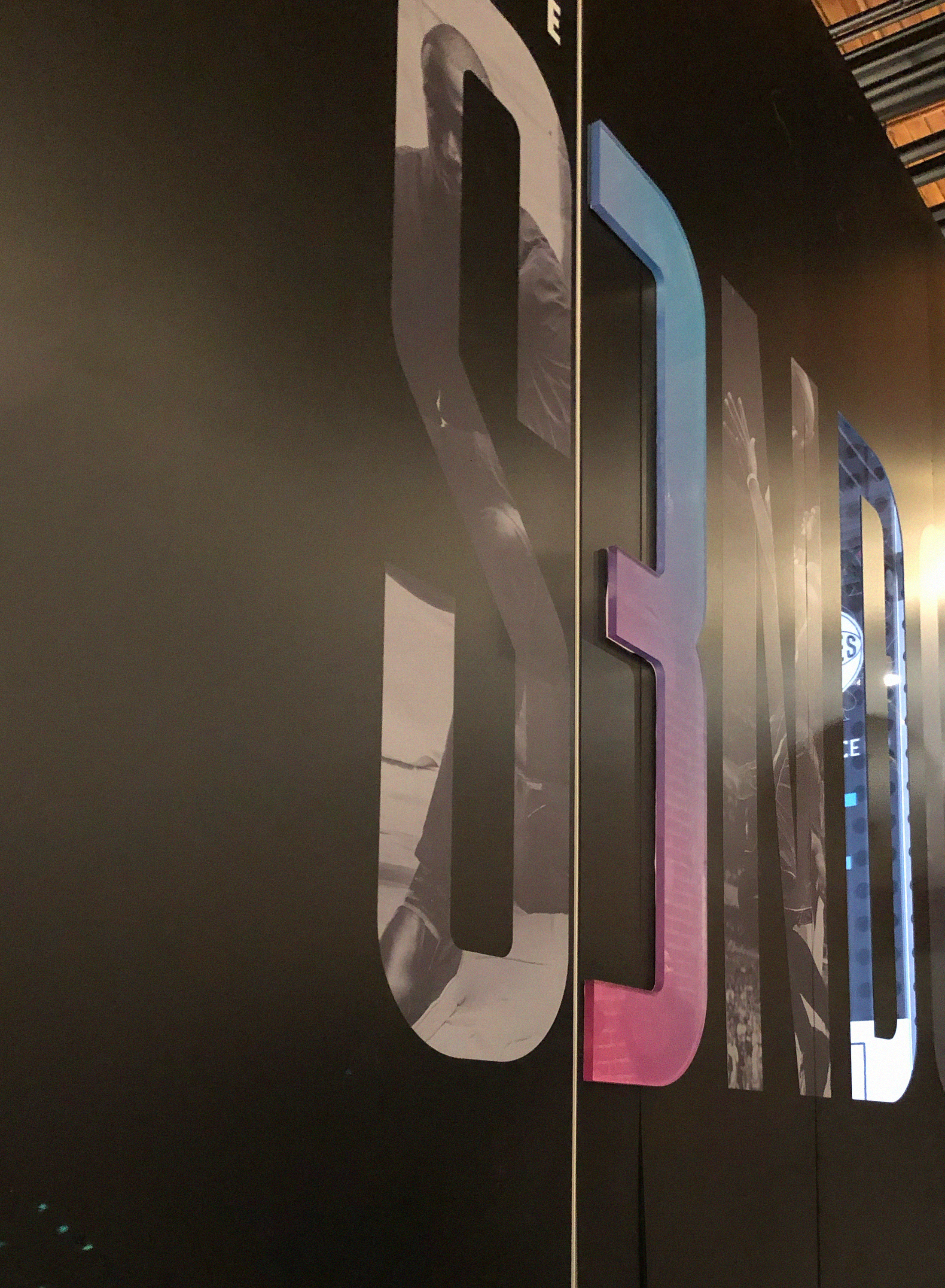 Close-up of the booth's layered S3NDOFF lettering with player photos cut into the letters