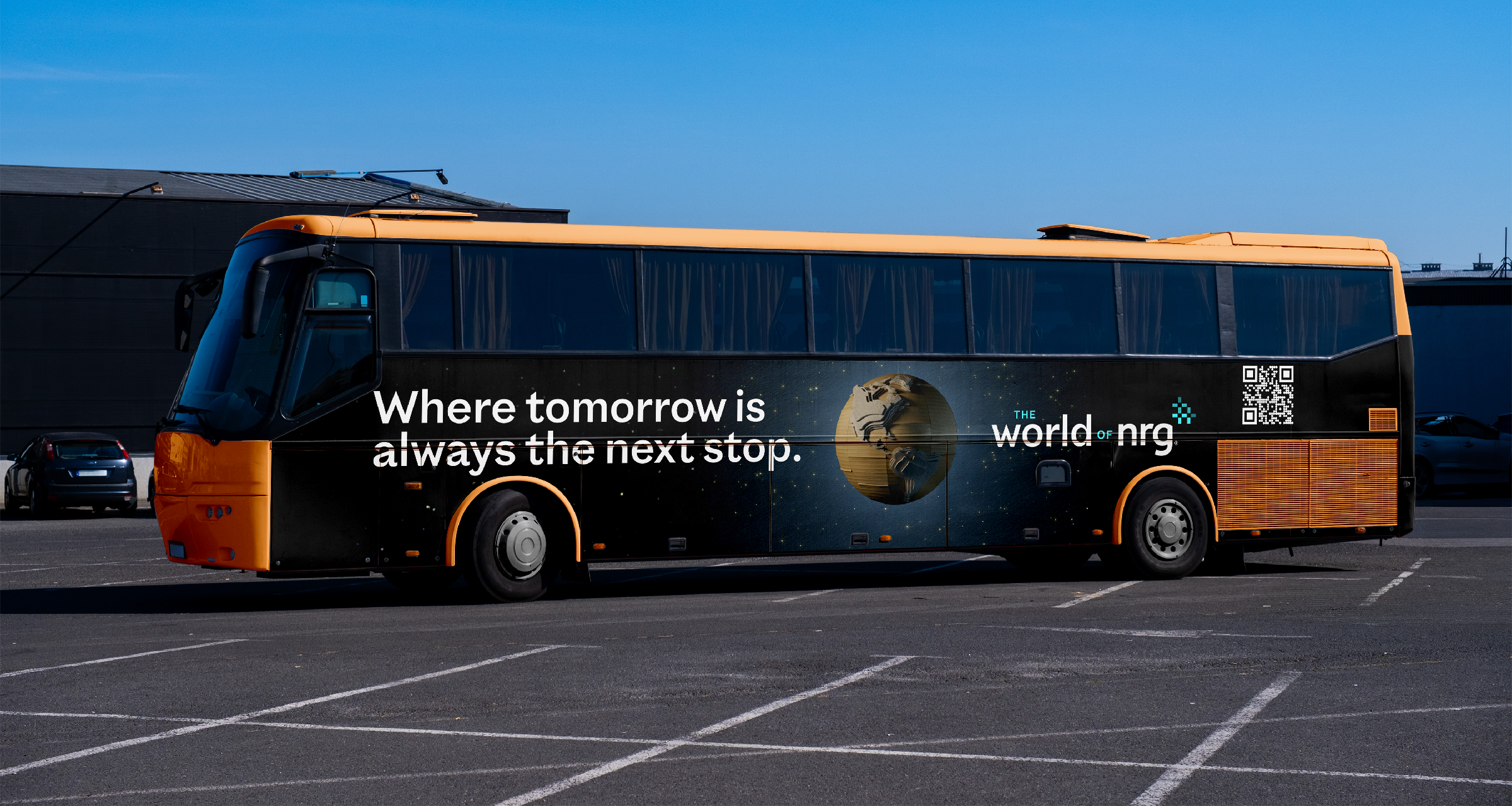 Coach bus wrapped in a World of NRG ad reading Where tomorrow is always the next stop